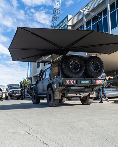 Universal awning that opens when canopy doors are up